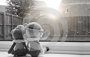 Two knitting dolls boy and girl holding hand sitting next to the window, Black and white colour