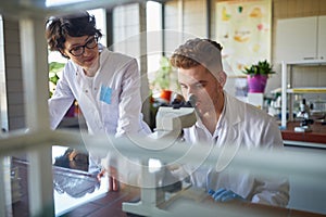 Two laborant practitioners analyzing samples
