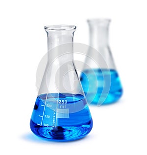 Two laboratory glass beakers with liquid samples