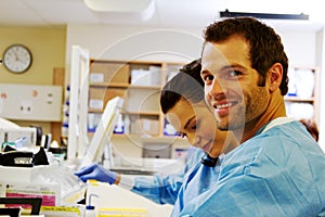 Two laboratory technicians working in hospital lab