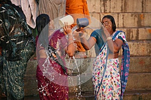 Two ladies washing in the ganges river