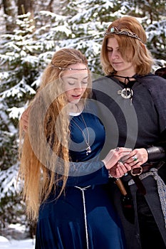 Two ladies in winter forest