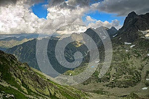 Two lakes hidden high in mountain in between rocky peaks