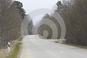 Two-lane asphalt road with trees