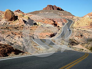 Two-lane road weaving through desert