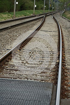 Two lanes or tracks of rails meeting in perspective into one, fusion of two rail lanes or tracks, the photo can have a symbolic me