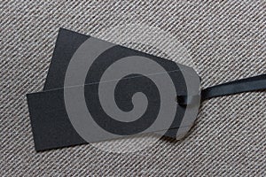 Two large black sale tags labels on fabric