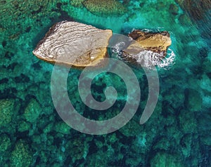 Two large boulders protrude from the water. Top view photo