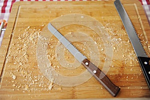 Two large bread knife on a cutting board