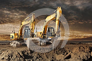 Two large excavator moving stone or soil in a quarry at a construction site. Heavy construction hydraulic equipment. Excavation