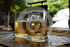 Two large glass mugs with beer