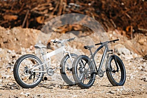 Two large off-road two-wheeled bicycles with male Fat bike frames.