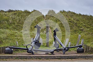 Two Large old Bower Anchors in front of the dunes at Cefn Sidan in South Wales