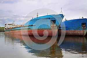 Two large rusty tankers on moorage in Volga river photo