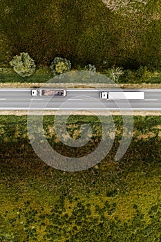 Two large transporter semi-trucks on the road, aerial view