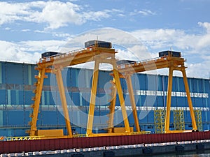 Two Large Yellow Gantry Cranes