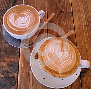 Two lattes with wooden spoons photo