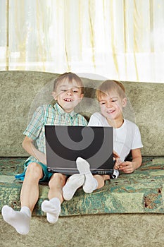 Two laughing boys with notebook