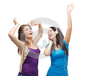 Two laughing girls with headphones dancing