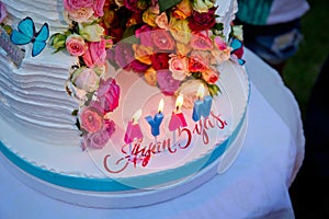 Two-layer cake . Wedding cake decorated with colorfull roses. Celebration party concept. flowers in the middle of the place where