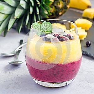 Two layer smoothie with black currant, quick oats, yogurt and pineapple, banana, square