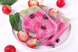 Two-layered ice cream popsicle with berries