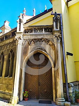 two-leaf wooden door under a semicircular arch of stone