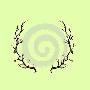 two leafy wood branches form a circle resembling deer antlers on a green background