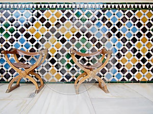 Two Leather Chairs with Patterned Tile Wall