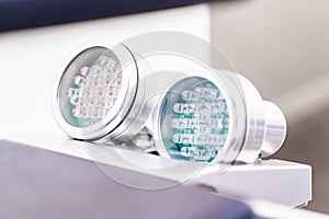 Two LED light therapies for skin, on handles, showing light bulbs. Red LED light for anti-aging and skin smoothing treatment and photo
