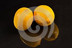 Two lemons on a black background