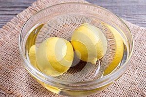 Two lemons in a bowl of water