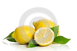 Two lemons and half with leaves