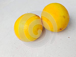 A fresh lemon with yellow skin that is still intact. photo