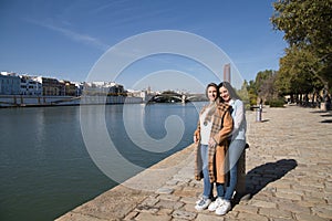 Two lesbian women are in a park next to a river. The women are young and newlyweds celebrating their honeymoon. Concept lgtb, gays