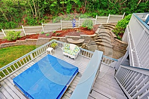 Two level backyard deck with jacuzzi on the first floor and patio area on the second one