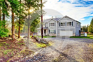 Two level blue country farm house with rocks trim