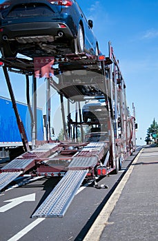 Two levels car hauler semi truck unloading cars