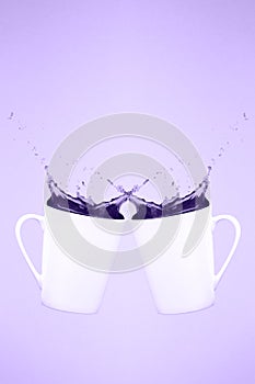 Two levitating coffee mugs with splashes. Coffee concept. Minima