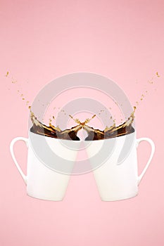 Two levitating coffee mugs with splashes. Coffee concept. Minima