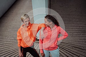 Two lgbt woman resting after a hard training in an urban environment