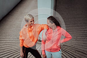 Two lgbt woman resting after a hard training in an urban environment