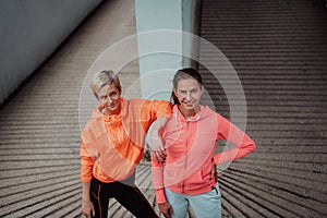 Two lgbt woman resting after a hard training in an urban environment