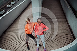 Two lgbt woman resting after a hard training in an urban environment