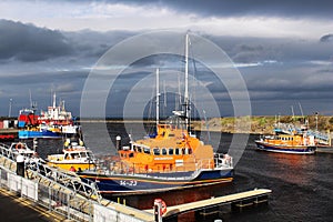 Two lifeboats and other vessels in Girvan Harbour.