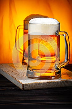 Two Light Beer Mugs with White Foam