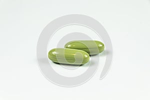 Two light green soft gelatine capsules.