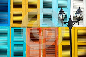 Two-light street lamp with colorful window background