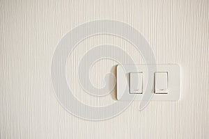 Two lighting switchs on concrete wall, on and off