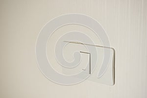 Two lighting switchs on concrete wall, on and off